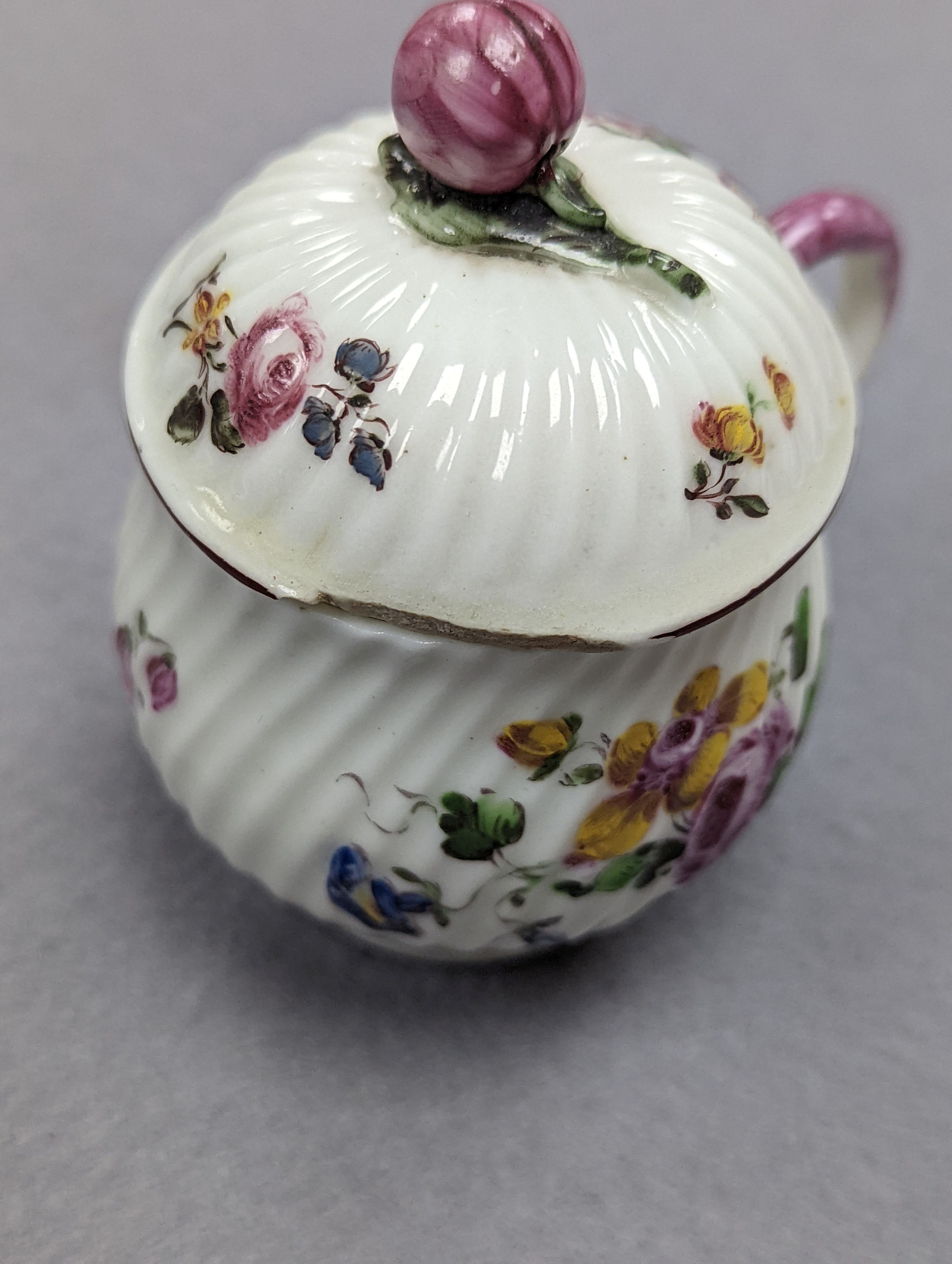 An 18th century Mennecy porcelain cup and cover, a Meissen style cup and cover, an English porcelain floral encrusted double inkwell and cover and a similar jar and cover